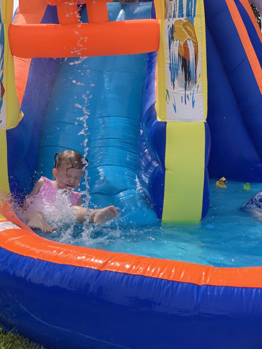 little girl on an inflatable water slide in summer 2022 11 07 05 45 56 utc min scaled Water slide rental | Lake, Nona FL